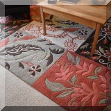 D12. Wool floor rug floral. Measures approx. 6'1” x 9' 